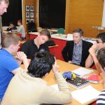 group of students and teachers gathered around a table